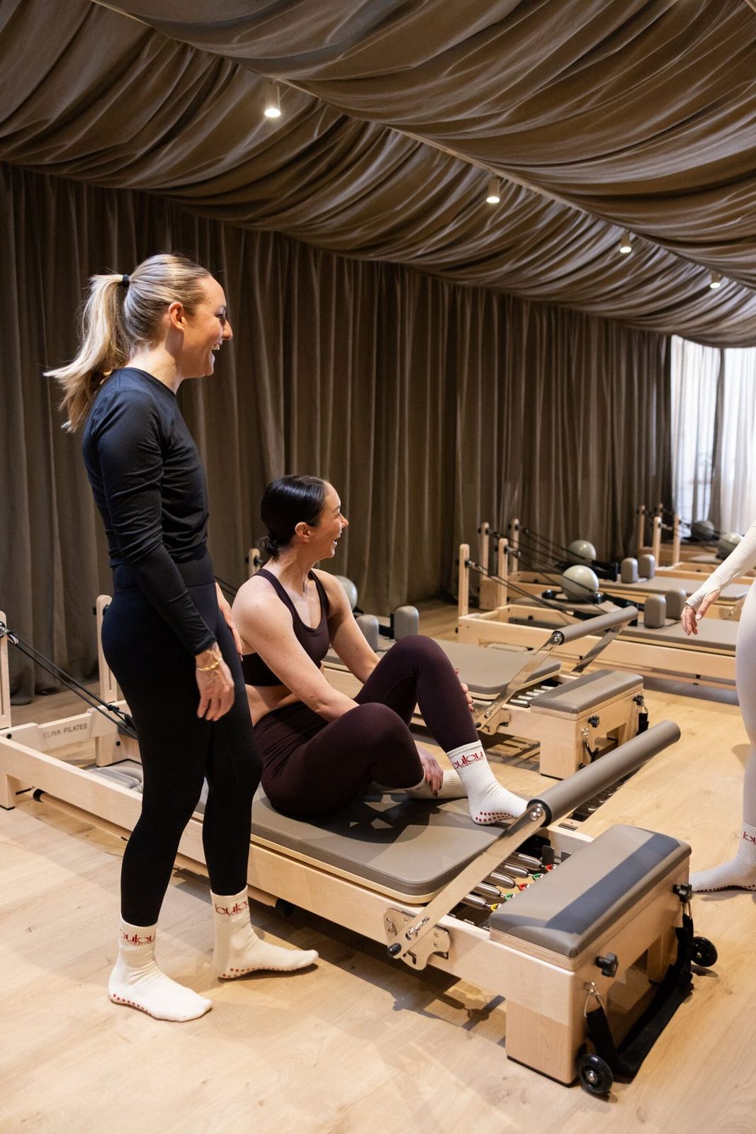 Instructeur geeft een reformerles in de studio van Loulou